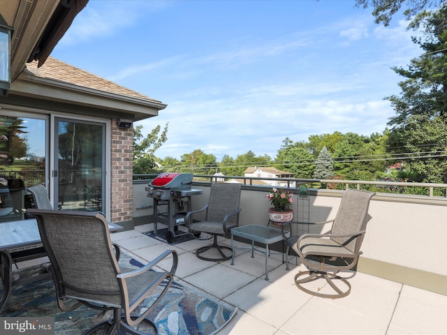 view of patio featuring a balcony and a grill