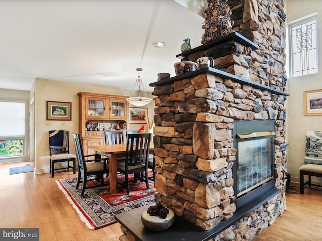 dining area with a fireplace and light hardwood / wood-style flooring