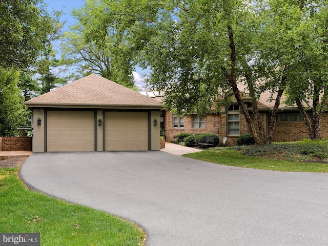3596 Eagle Dr, Chambersburg, PA 17202 - view of front of house with brick siding, aphalt driveway, roof with shingles, and an attached garage