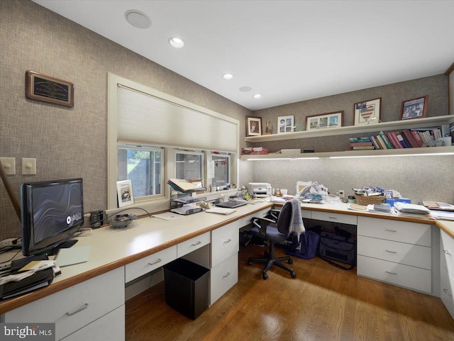 office featuring built in desk and hardwood / wood-style floors