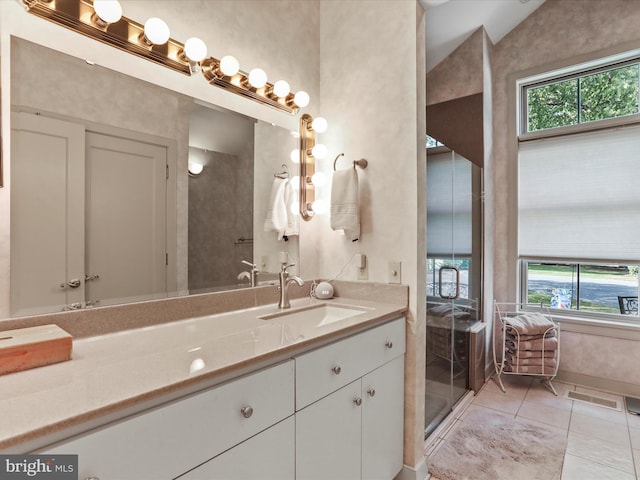 bathroom featuring vanity, a shower with shower door, vaulted ceiling, and tile patterned floors