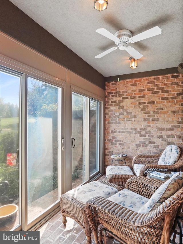3596 Eagle Dr, Chambersburg, PA 17202 - sunroom with brick floor, brick wall, and a textured ceiling
