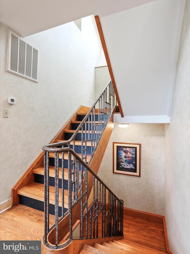 stairs with hardwood / wood-style floors