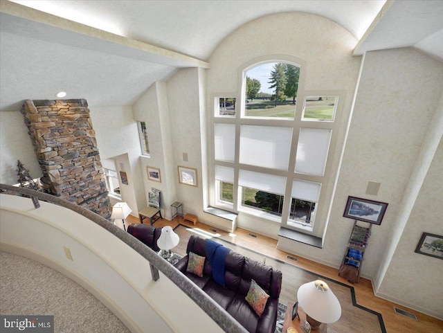 living room with vaulted ceiling and hardwood / wood-style flooring