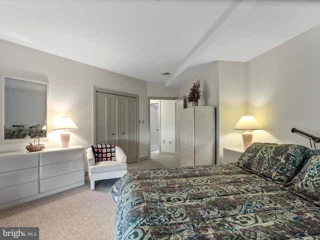 bedroom featuring light carpet and a closet