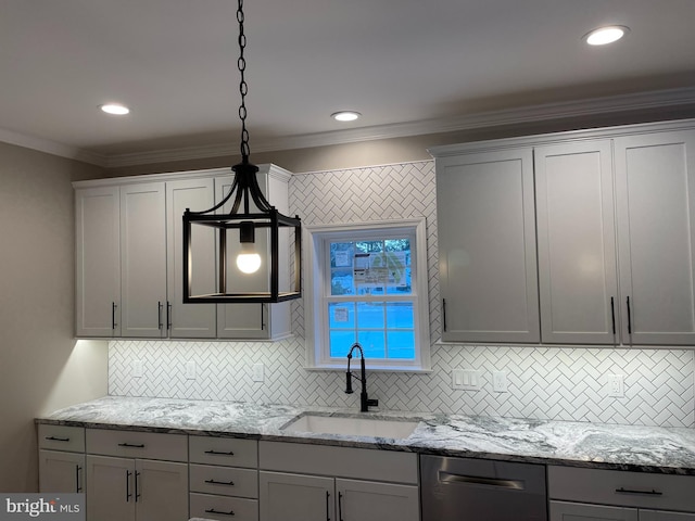 kitchen with light stone countertops, crown molding, hanging light fixtures, sink, and decorative backsplash