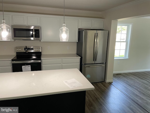 kitchen featuring ornamental molding, decorative light fixtures, dark wood-type flooring, appliances with stainless steel finishes, and white cabinets