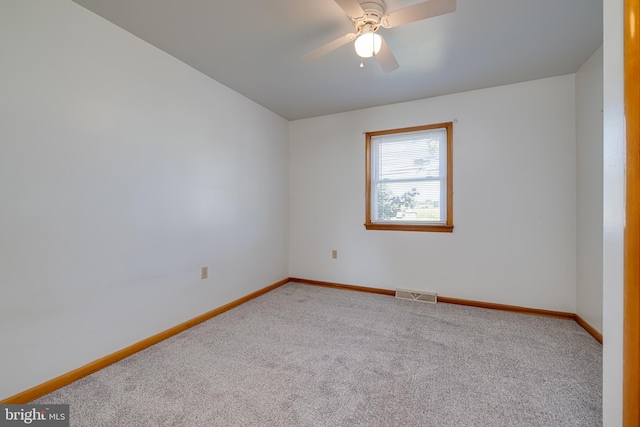 empty room featuring visible vents, ceiling fan, baseboards, and carpet floors