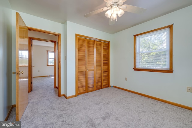 unfurnished bedroom featuring carpet, a closet, and baseboards