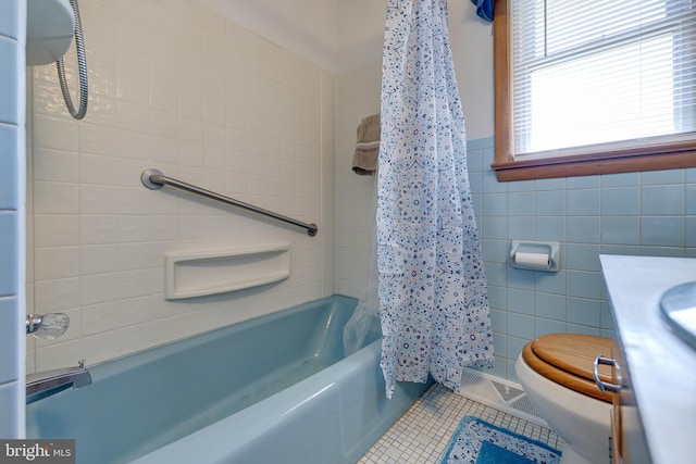 bathroom with visible vents, shower / bath combo, tile walls, toilet, and tile patterned floors