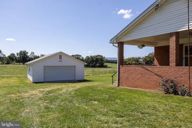 view of yard with an outbuilding and a detached garage