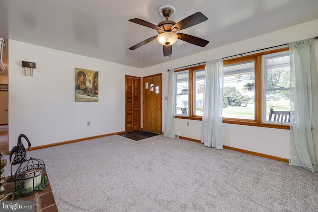 interior space featuring a ceiling fan and baseboards