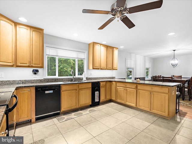 kitchen featuring recessed lighting, a peninsula, black appliances, and a sink