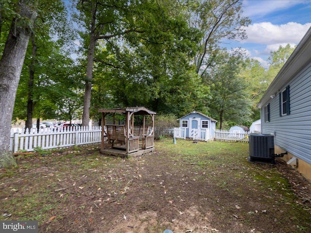 view of yard featuring a pergola and central AC