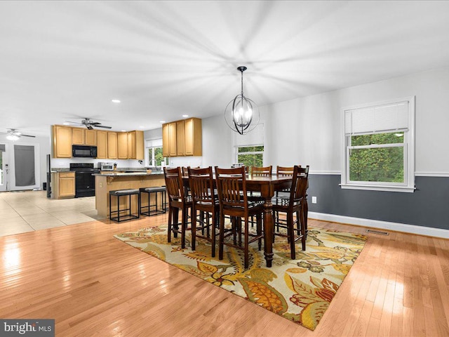 dining area featuring ceiling fan with notable chandelier, recessed lighting, baseboards, and light wood-type flooring