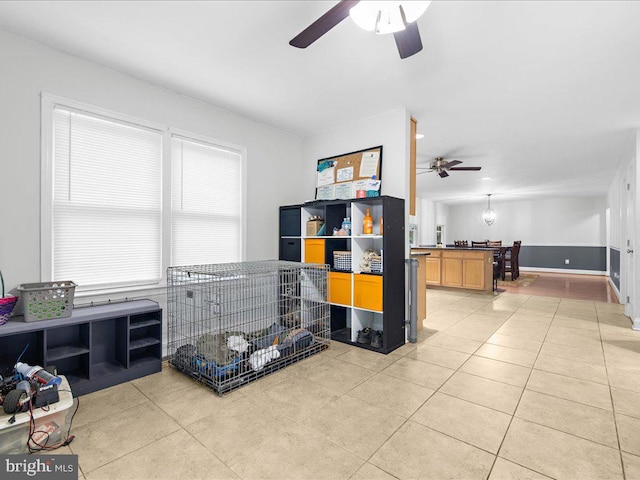 misc room featuring ceiling fan and light tile patterned floors