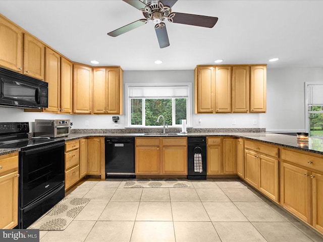 kitchen with black appliances, dark stone countertops, light tile patterned flooring, and sink