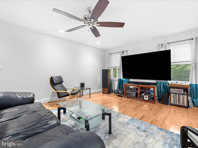 living room with wood-type flooring and ceiling fan