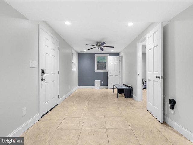 foyer entrance with ceiling fan and light tile patterned floors