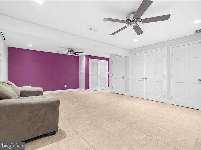 sitting room featuring ceiling fan and light tile patterned flooring