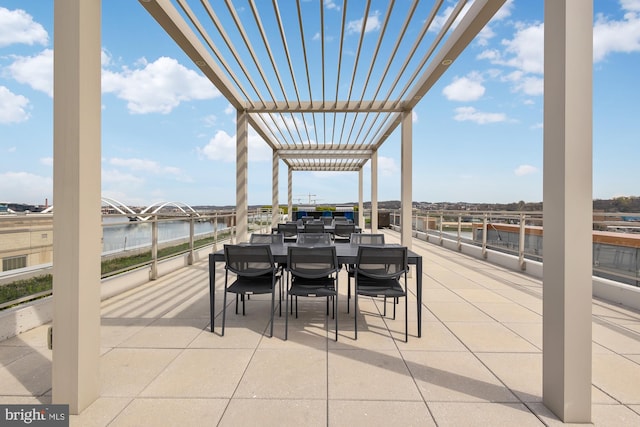 view of patio / terrace with a water view and a pergola