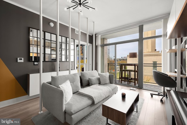 living room featuring a notable chandelier, expansive windows, and wood-type flooring