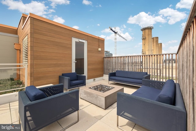 view of patio with an outdoor living space with a fire pit