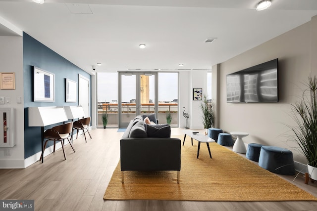 living room featuring expansive windows and hardwood / wood-style floors