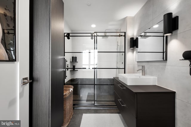 bathroom with a shower with shower door, concrete floors, and vanity