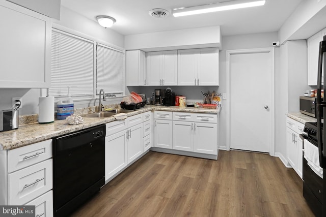 kitchen featuring black appliances, white cabinetry, hardwood / wood-style flooring, and sink