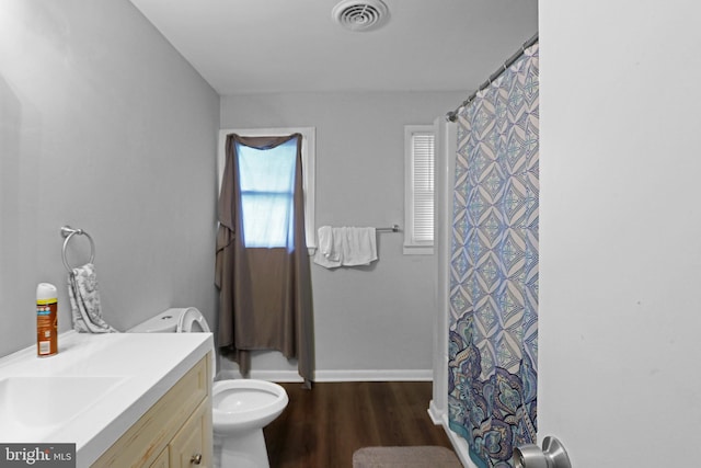 bathroom with vanity, toilet, hardwood / wood-style floors, and curtained shower