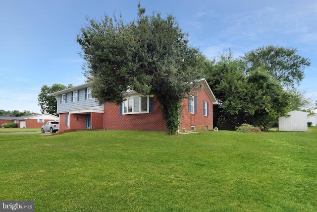 view of front of property with a front yard and a storage unit