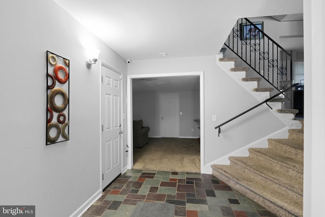 entryway with dark colored carpet