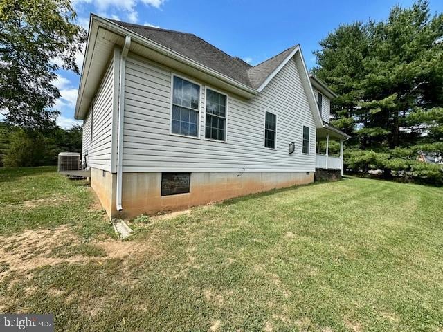 view of home's exterior featuring a yard and central AC unit