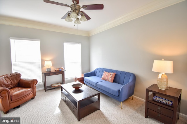 carpeted living room with crown molding, a ceiling fan, and baseboards