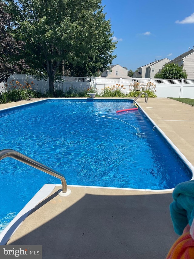 view of swimming pool featuring a patio area, a fenced in pool, and a fenced backyard