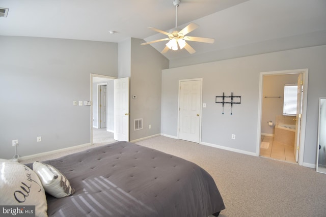 carpeted bedroom with visible vents, baseboards, ensuite bath, and vaulted ceiling