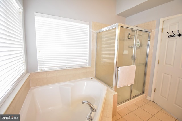 bathroom with tile patterned floors, a garden tub, and a shower stall