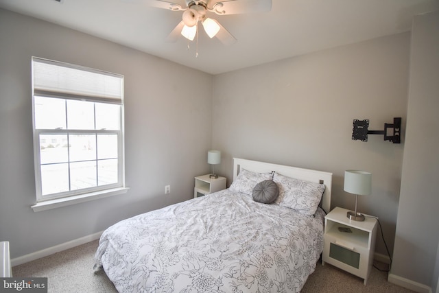 carpeted bedroom with a ceiling fan and baseboards