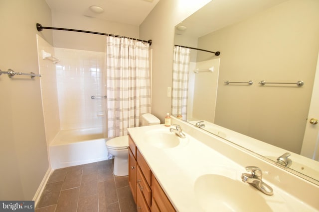 full bath with a sink, shower / bath combo with shower curtain, toilet, and double vanity