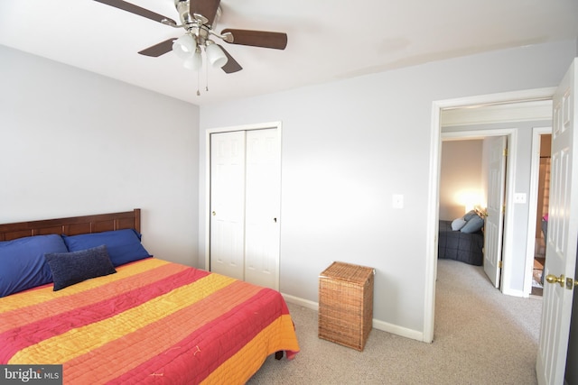 carpeted bedroom featuring ceiling fan and a closet