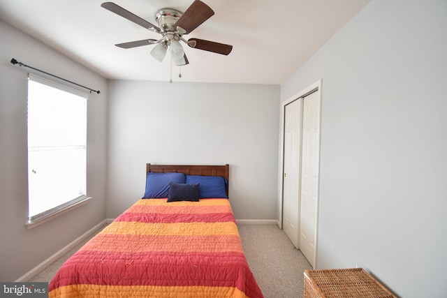 bedroom with multiple windows, baseboards, a closet, and carpet floors