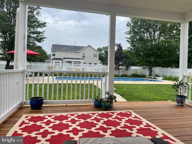 wooden deck featuring a fenced in pool, a yard, and a fenced backyard