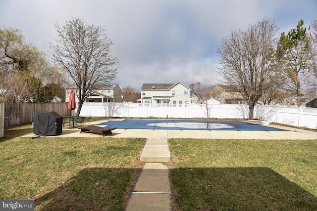 view of yard featuring a patio area, a fenced in pool, and a fenced backyard