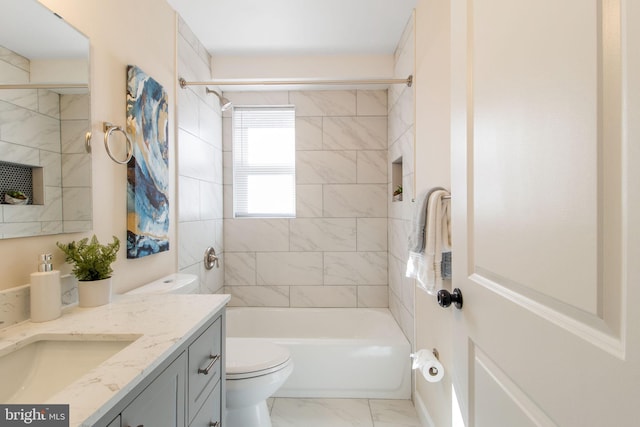 full bathroom featuring vanity, toilet, and tiled shower / bath