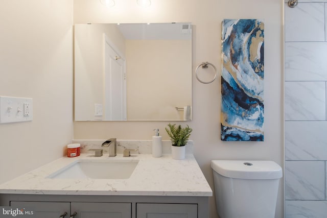 bathroom featuring vanity and toilet