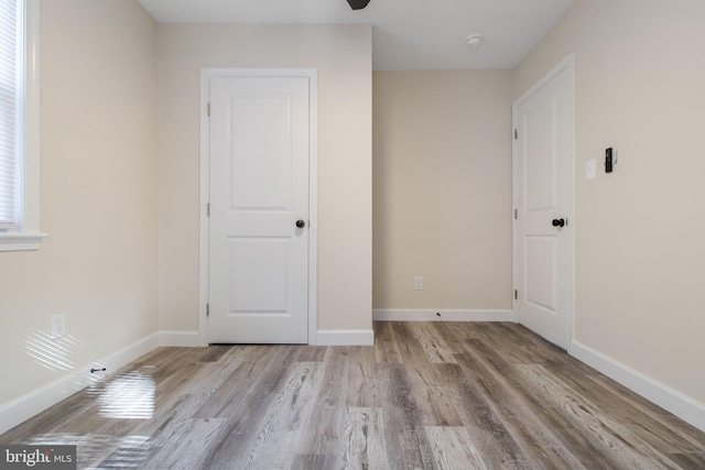 spare room featuring ceiling fan and light hardwood / wood-style flooring