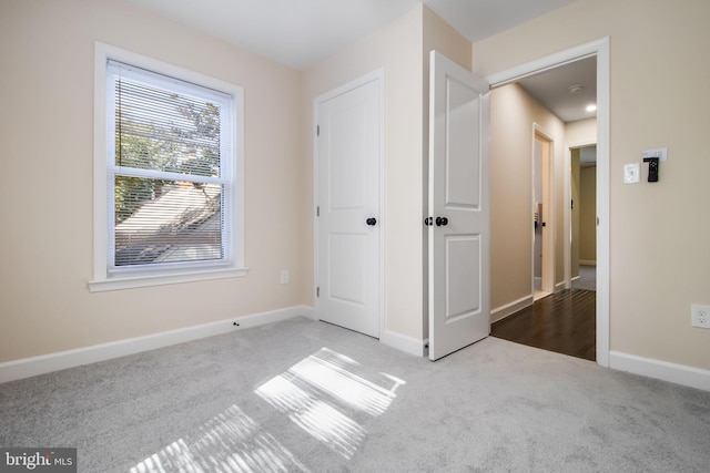 unfurnished bedroom featuring light colored carpet