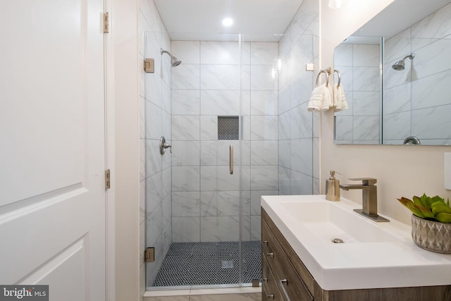 bathroom featuring an enclosed shower and vanity