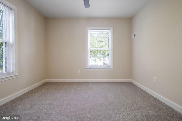 spare room with carpet floors and ceiling fan